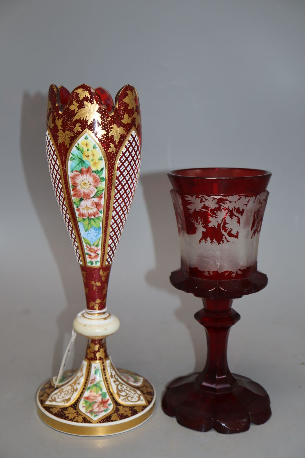 A Bohemian etched ruby glass goblet, together with a gilded cranberry glass vase, tallest 29cm